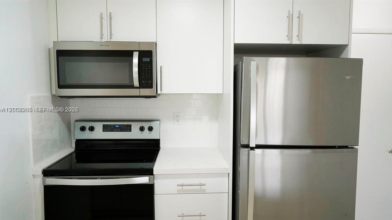 2771 Riverside Drive, Unit 405A Coral Springs, FL 33065 - Photo 2 of 19 a kitchen with a stove and a microwave
