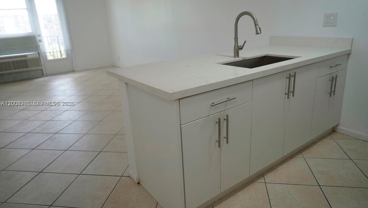 2771 Riverside Drive, Unit 405A Coral Springs, FL 33065 - Photo 5 of 19 a kitchen with a sink and cabinets