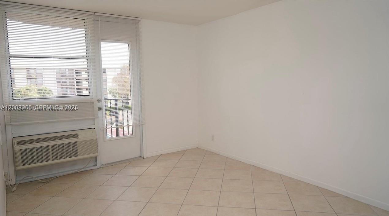 2771 Riverside Drive, Unit 405A Coral Springs, FL 33065 - Photo 9 of 19 an empty room with windows