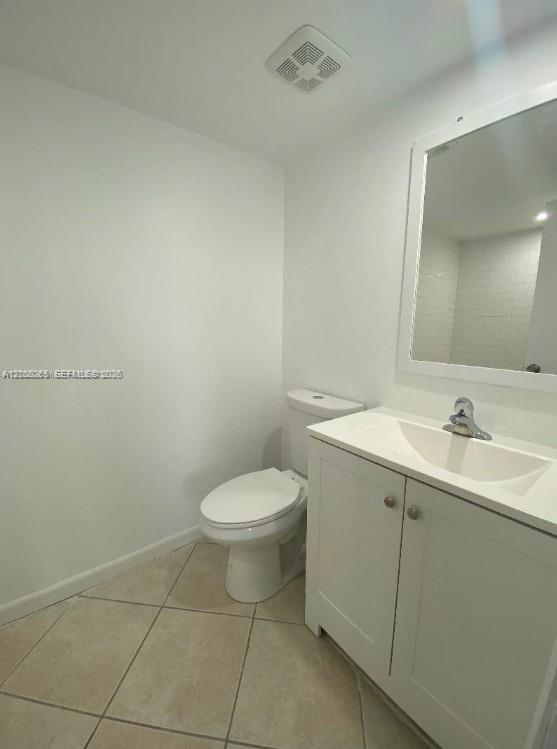 2771 Riverside Drive, Unit 405A Coral Springs, FL 33065 - Photo 10 of 19 a bathroom with a toilet sink and mirror