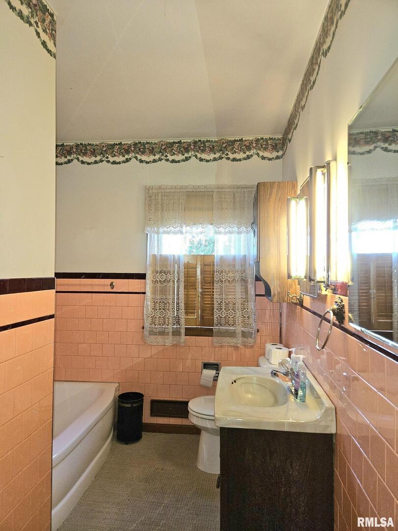 918 Seminary Street Wilton, IA 52778 - Photo 12 of 12 a bathroom with a sink and a mirror