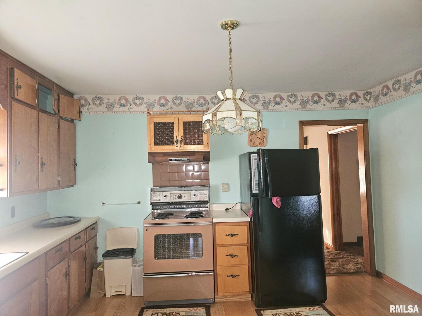 918 Seminary Street Wilton, IA 52778 - Photo 5 of 12 a kitchen with stainless steel appliances a refrigerator and a stove