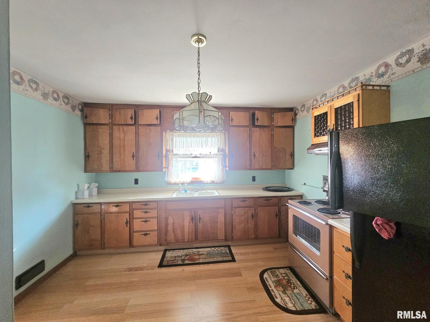 918 Seminary Street Wilton, IA 52778 - Photo 6 of 12 a kitchen with granite countertop a sink a counter and appliances