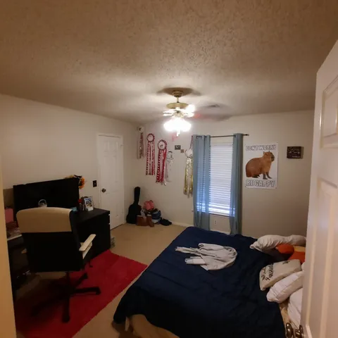 a bedroom with furniture and a chandelier