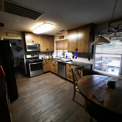 a kitchen with lots of counter top space and stainless steel appliances