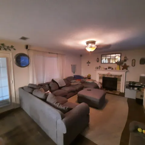 a living room with furniture a fireplace and a window