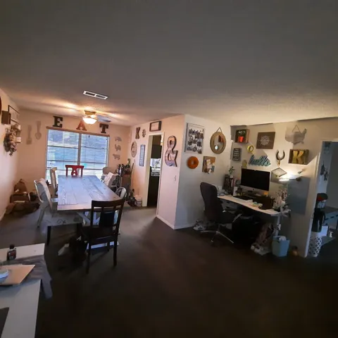 a view of a dining room with furniture and a table