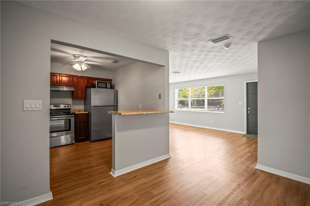 2259 Carrell Road Fort Myers, FL 33901 - Photo 9 of 28 a kitchen with stainless steel appliances a refrigerator and a stove top oven