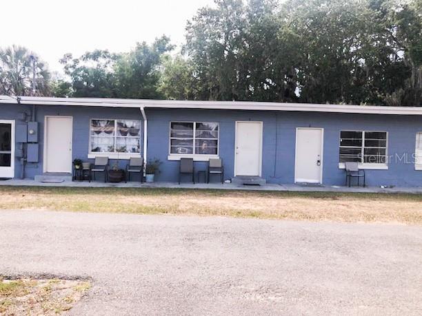 1401 East Alfred Street, Unit 3 Tavares, FL 32778 - Photo 1 of 10 a view of a house with a yard and a large tree