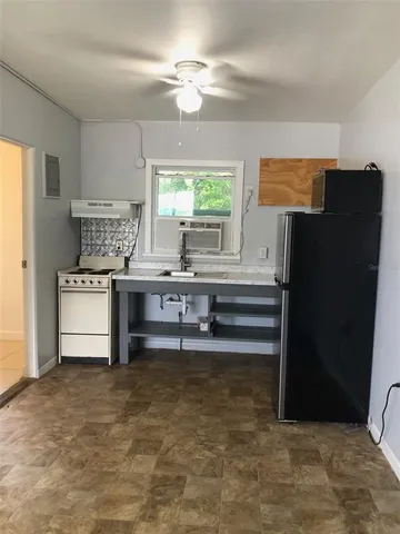 a kitchen with stainless steel appliances a refrigerator and a stove