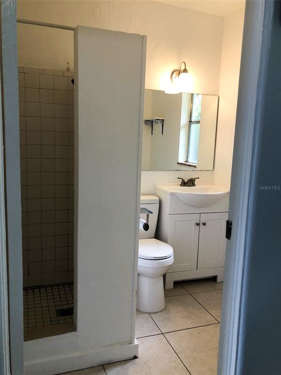 1401 East Alfred Street, Unit 3 Tavares, FL 32778 - Photo 5 of 10 a bathroom with a toilet sink and a mirror