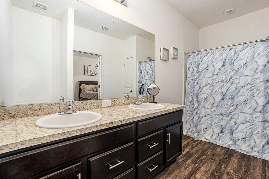5521 Yellowfin Court New Port Richey, FL 34652 - Photo 11 of 23 a bathroom with a granite countertop sink and a mirror