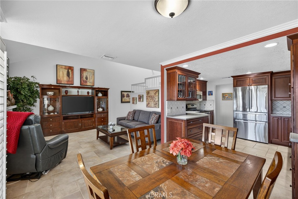 832 Trinity Lane Claremont, CA 91711 - Photo 12 of 51 a living room with furniture a flat screen tv and kitchen view