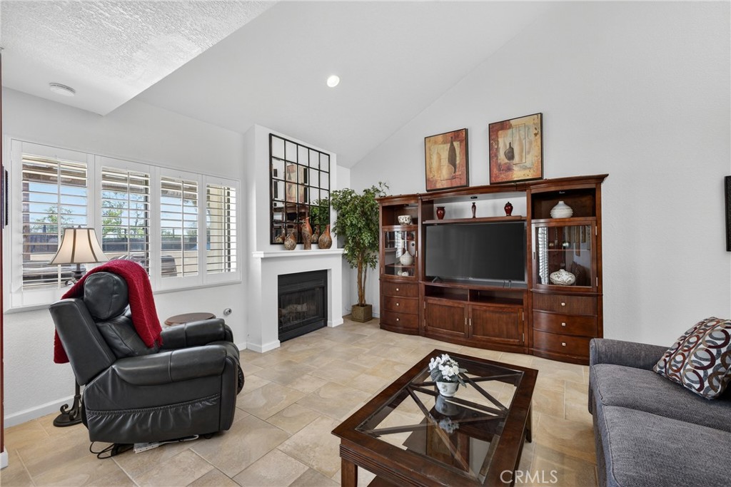 832 Trinity Lane Claremont, CA 91711 - Photo 14 of 51 a living room with furniture a flat screen tv and a fireplace