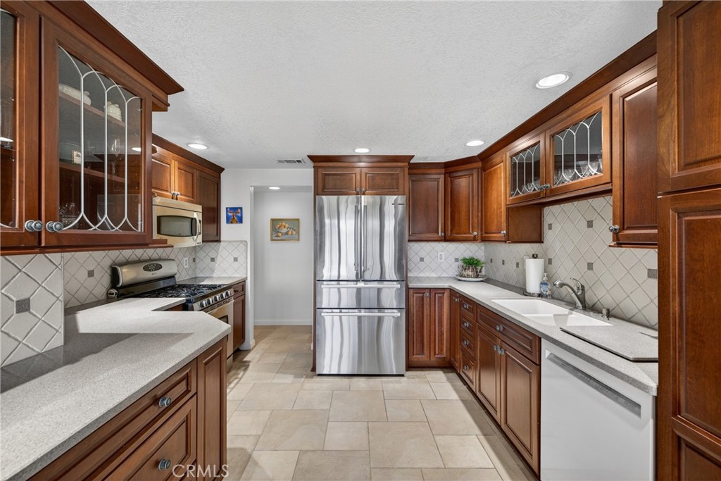 832 Trinity Lane Claremont, CA 91711 - Photo 17 of 51 a kitchen with stainless steel appliances granite countertop a sink stove and refrigerator