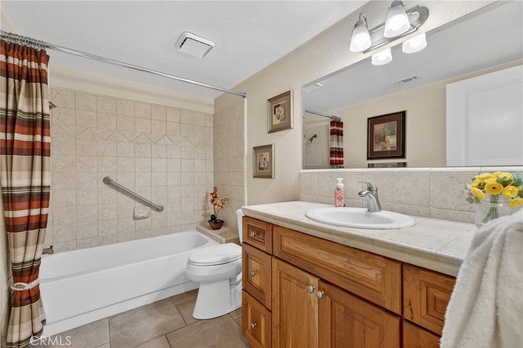 832 Trinity Lane Claremont, CA 91711 - Photo 21 of 51 a bathroom with a granite countertop sink a toilet a mirror and shower
