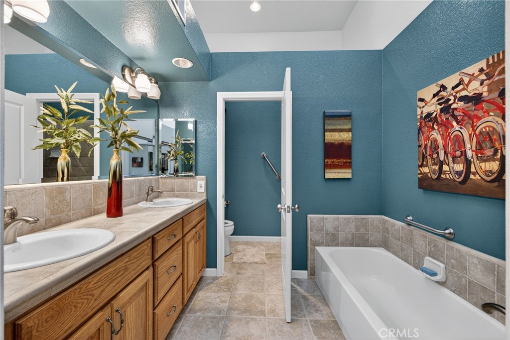 832 Trinity Lane Claremont, CA 91711 - Photo 29 of 51 a bathroom with a tub sink and mirror