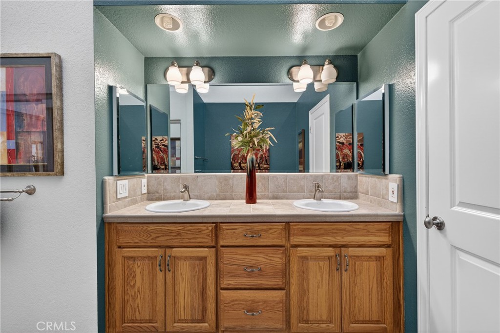 832 Trinity Lane Claremont, CA 91711 - Photo 31 of 51 a bathroom with a sink and a mirror