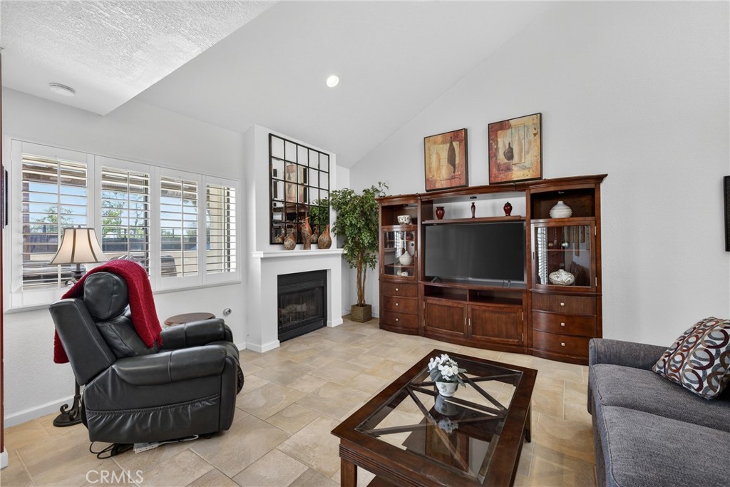 832 Trinity Lane Claremont, CA 91711 - Photo 9 of 51 a living room with furniture a flat screen tv and a fireplace