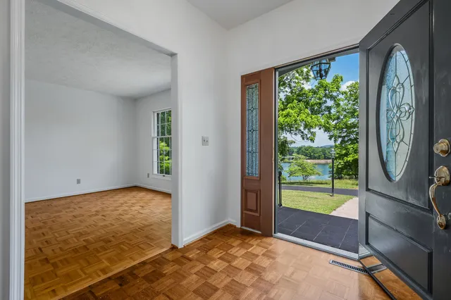 a kitchen with granite countertop a refrigerator and a stove top oven
