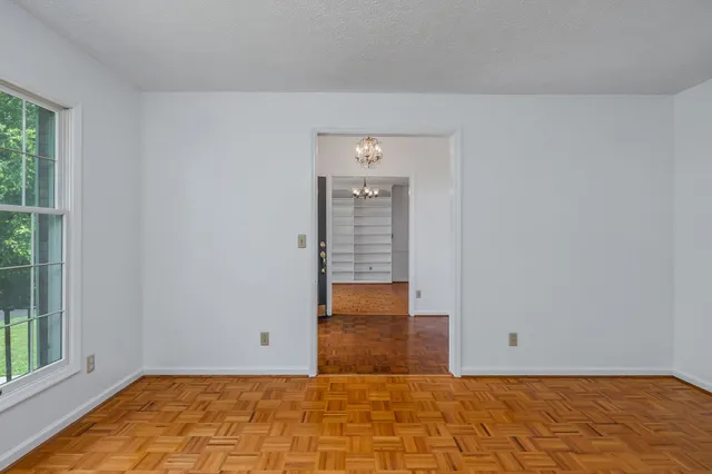 a view of a room with wooden floor and cabinet