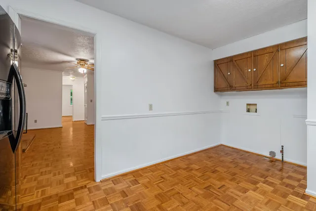 a bathroom with a granite countertop toilet sink and mirror