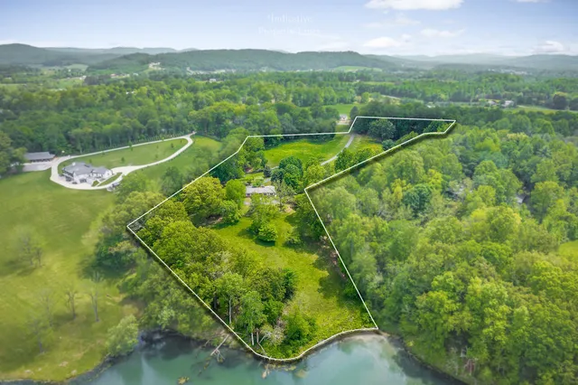 a view of a lush green hillside and a building