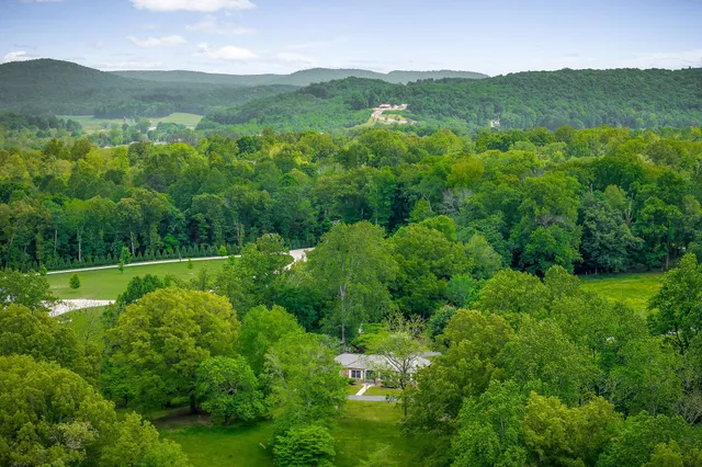 a swimming pool with outdoor seating and yard