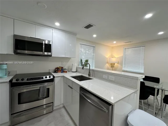 a kitchen with a stove and a sink