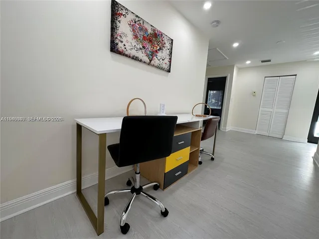 a view of a workspace with furniture