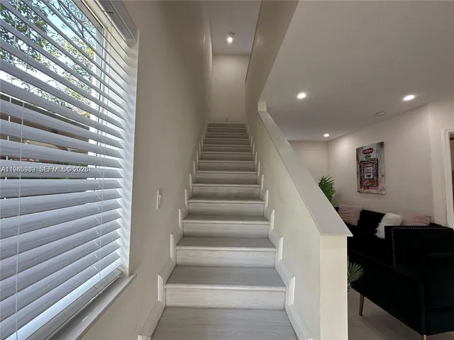 a kitchen with a refrigerator sink and a stove top oven