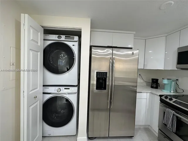 a kitchen with a sink stove and microwave
