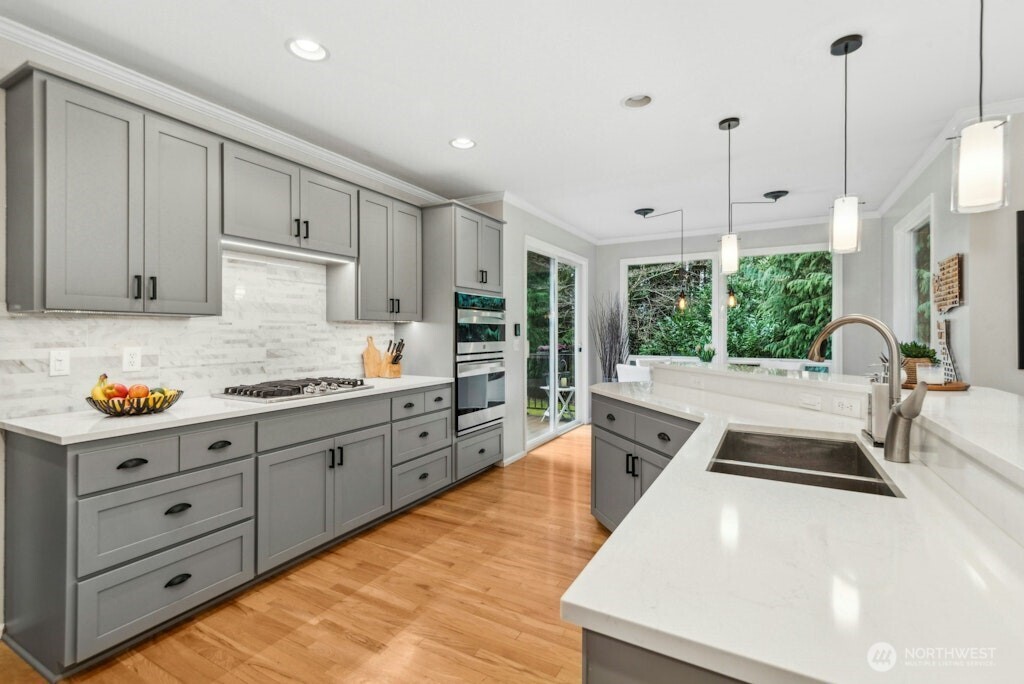 3020 215th Street Southeast Bothell, WA 98021 - Photo 8 of 35 a large kitchen with kitchen island a large window and stainless steel appliances