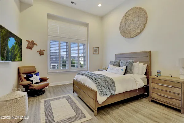 a bed room with a bed and a chair