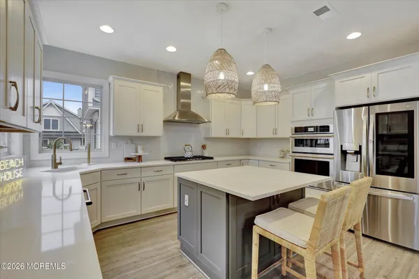 a kitchen with sink cabinets and stainless steel appliances
