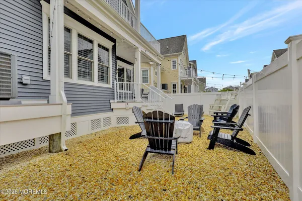 a view of a house with pool and chairs