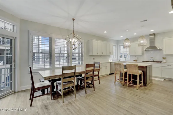 a large kitchen with a table and chairs