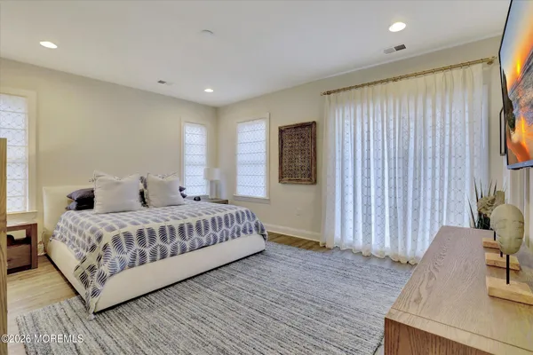 a spacious bedroom with a bed and a table