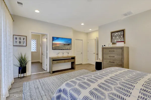 a bedroom with a bed and a television
