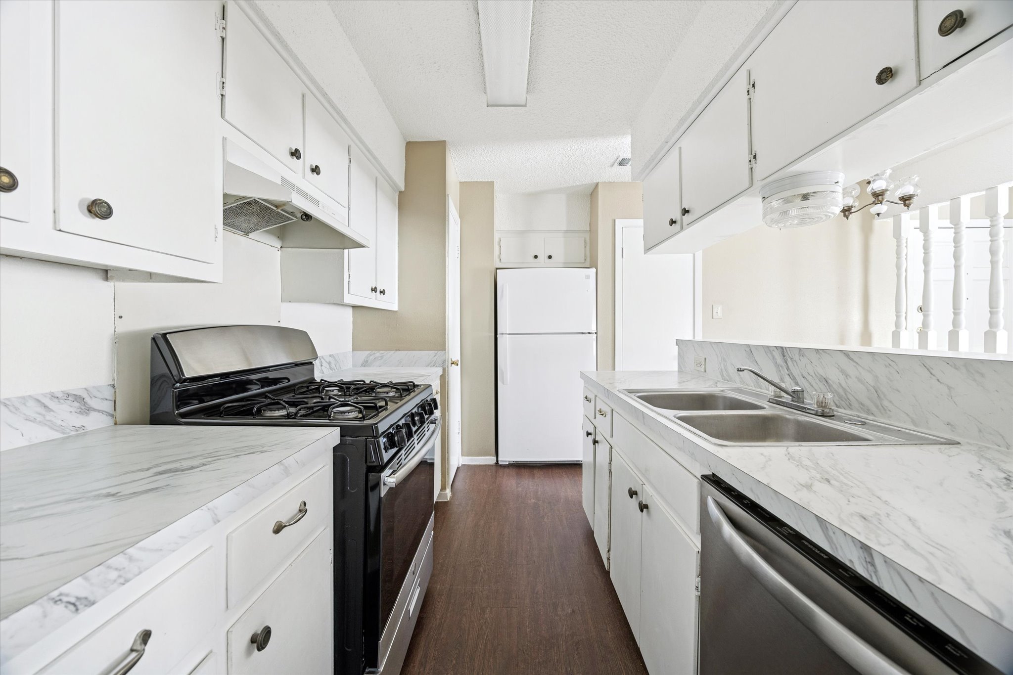 908 Kirschner Place, Unit B Austin, TX 78758 - Photo 4 of 10 a kitchen with granite countertop a sink stove and refrigerator