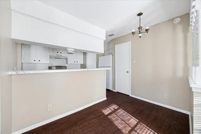 a room with wooden floor and cabinets