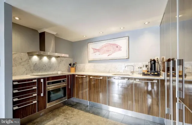 a kitchen with stainless steel appliances granite countertop a stove and a sink