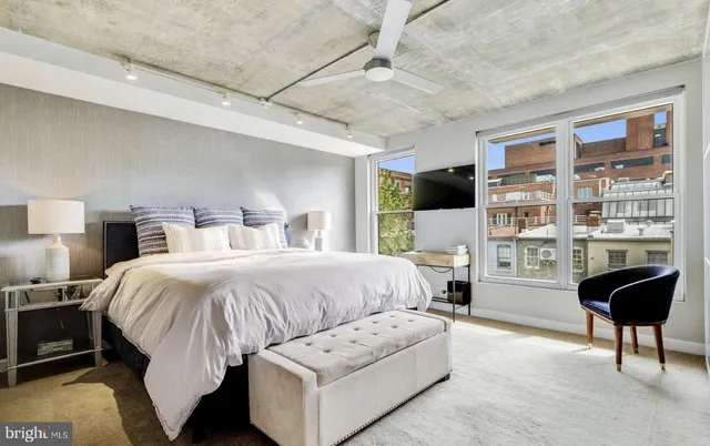 a spacious bedroom with a bed and a couch