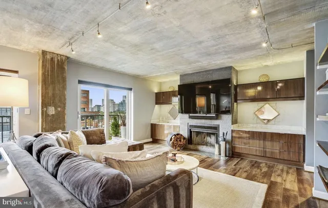 a living room with furniture and a fireplace