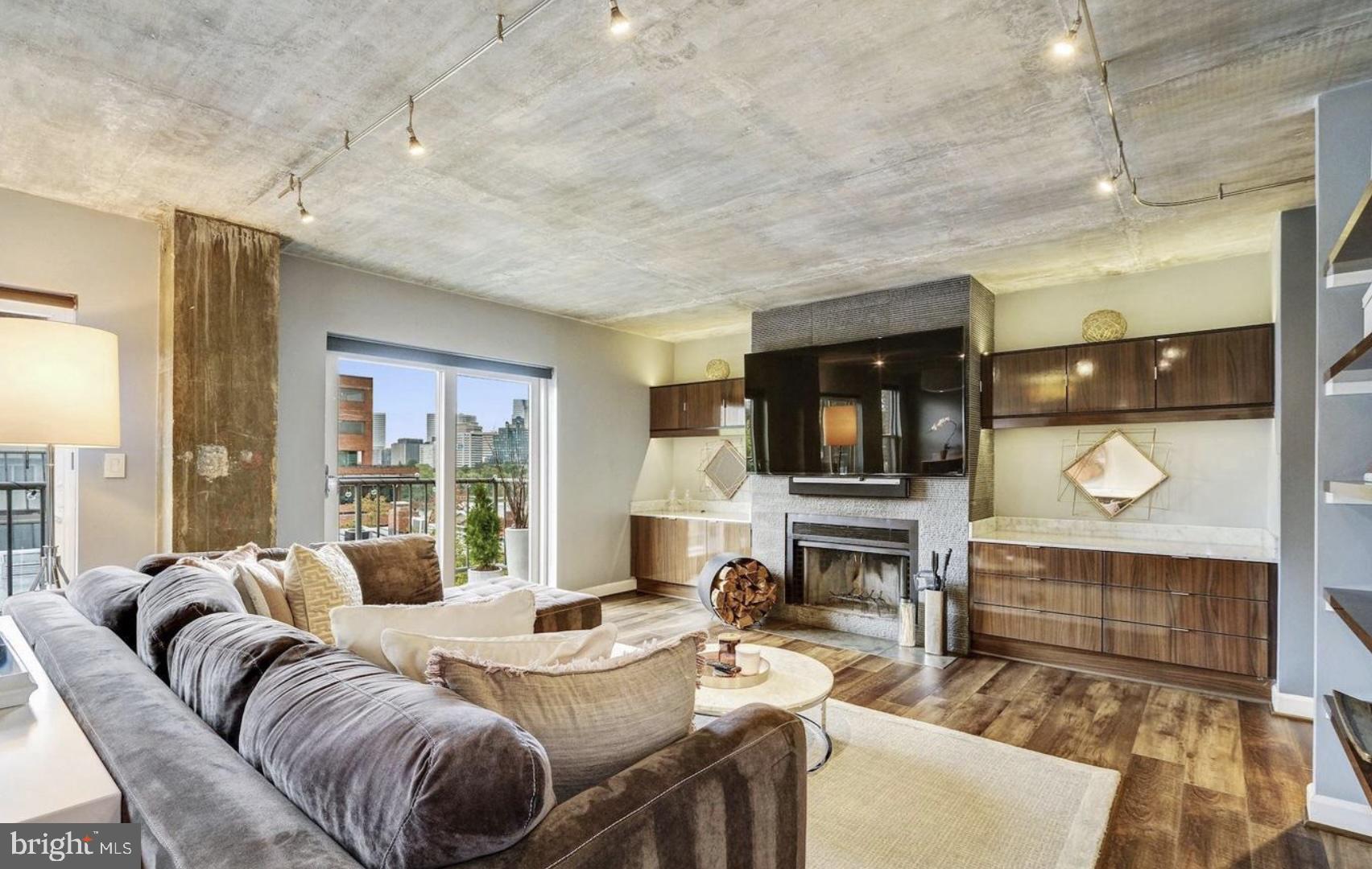 3210 Grace Street Northwest, Unit 308 Washington, DC 20007 - Photo 10 of 11 a living room with furniture and a fireplace