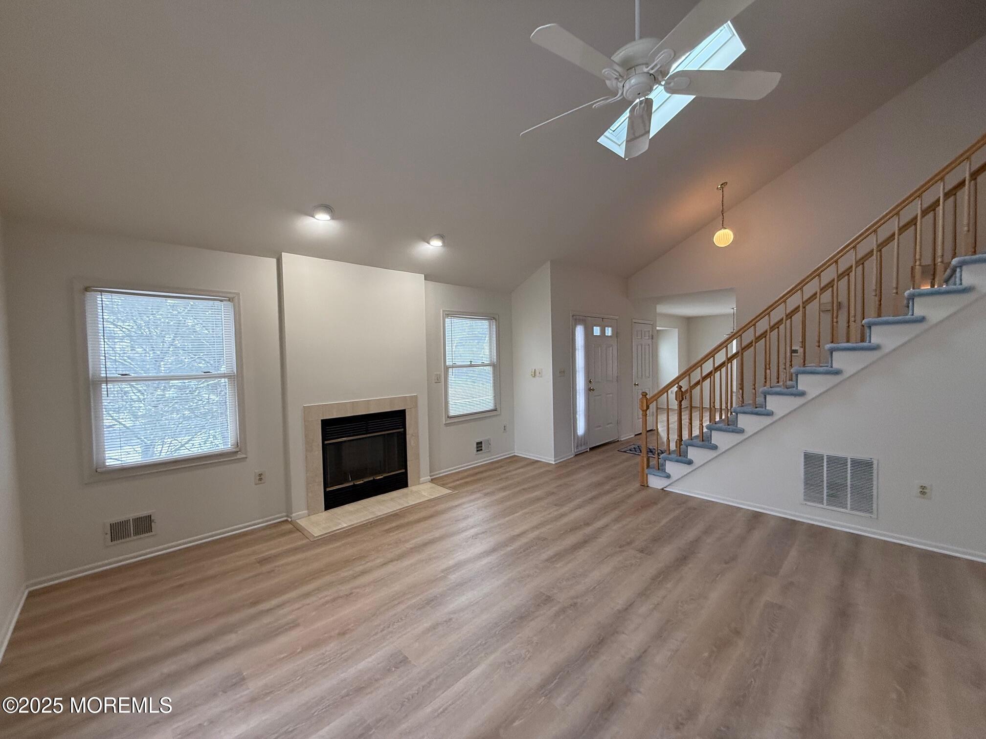 2 Whitesands Way Little Silver, NJ 07739 - Photo 1 of 9 a view of an empty room with chandelier fan and fire place