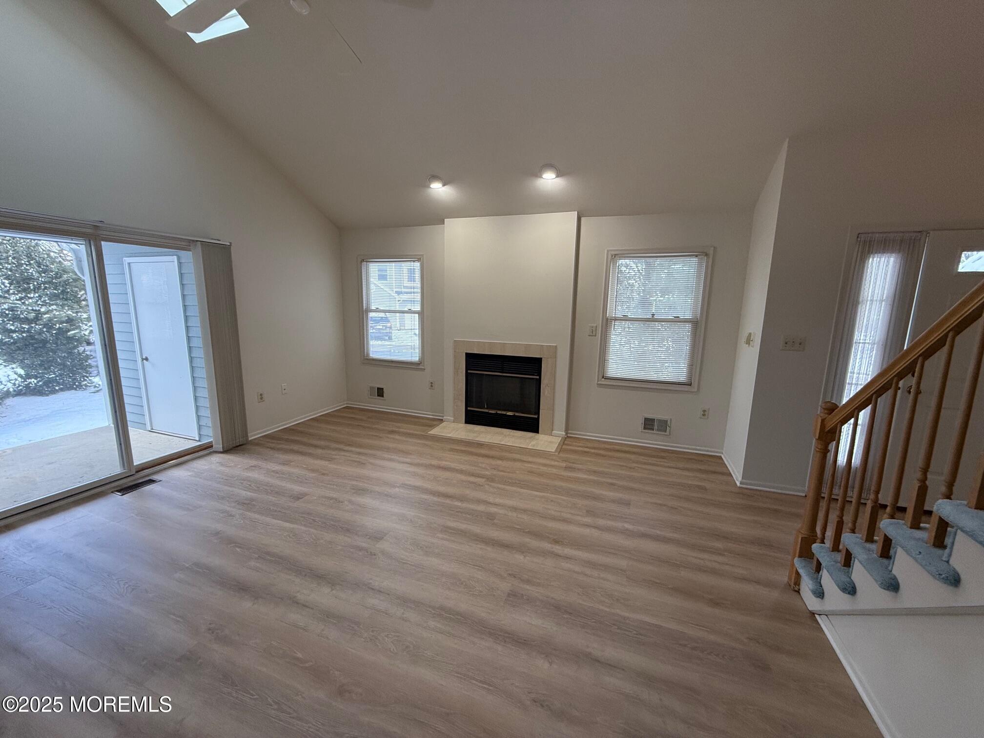 2 Whitesands Way Little Silver, NJ 07739 - Photo 3 of 9 an empty room with wooden floor and fireplace