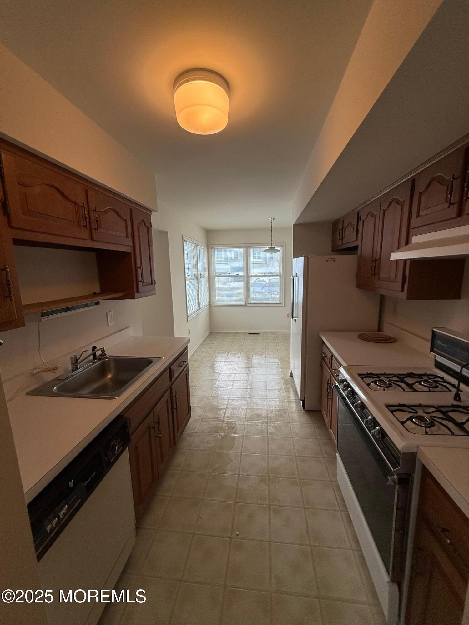 2 Whitesands Way Little Silver, NJ 07739 - Photo 7 of 9 a kitchen with a sink stove and cabinets