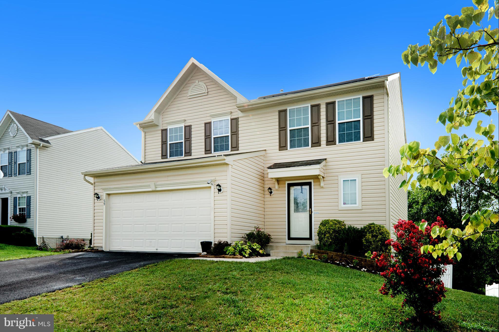 59 Haverhill Road Joppa, MD 21085 - Photo 1 of 28 a front view of a house with a garden and plants