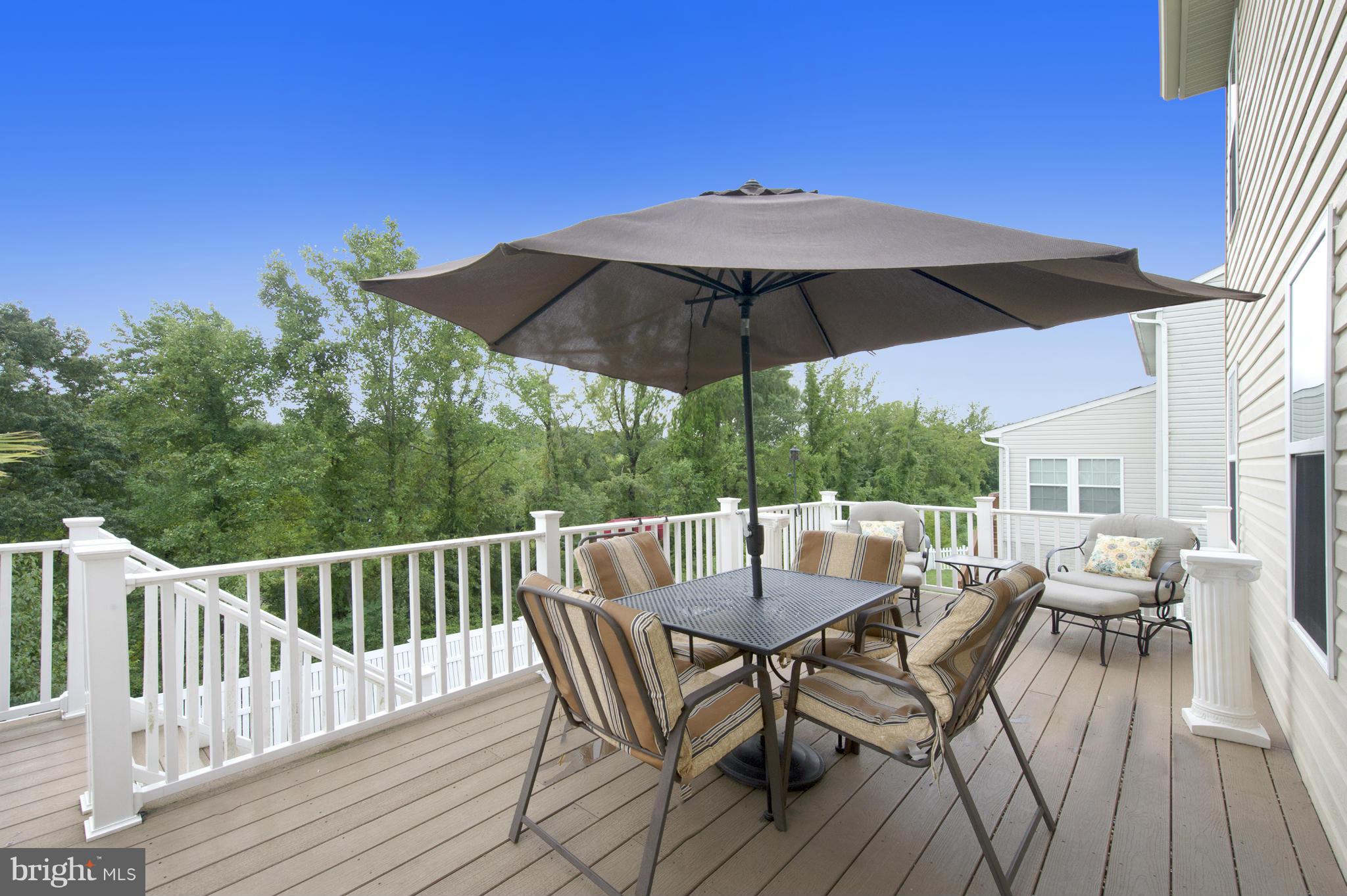 59 Haverhill Road Joppa, MD 21085 - Photo 12 of 28 a view of a roof deck with table and chairs under an umbrella